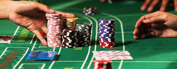 A baccarat player collects his chips from the baccarat table