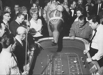 black & white image of people gathered around a craps table